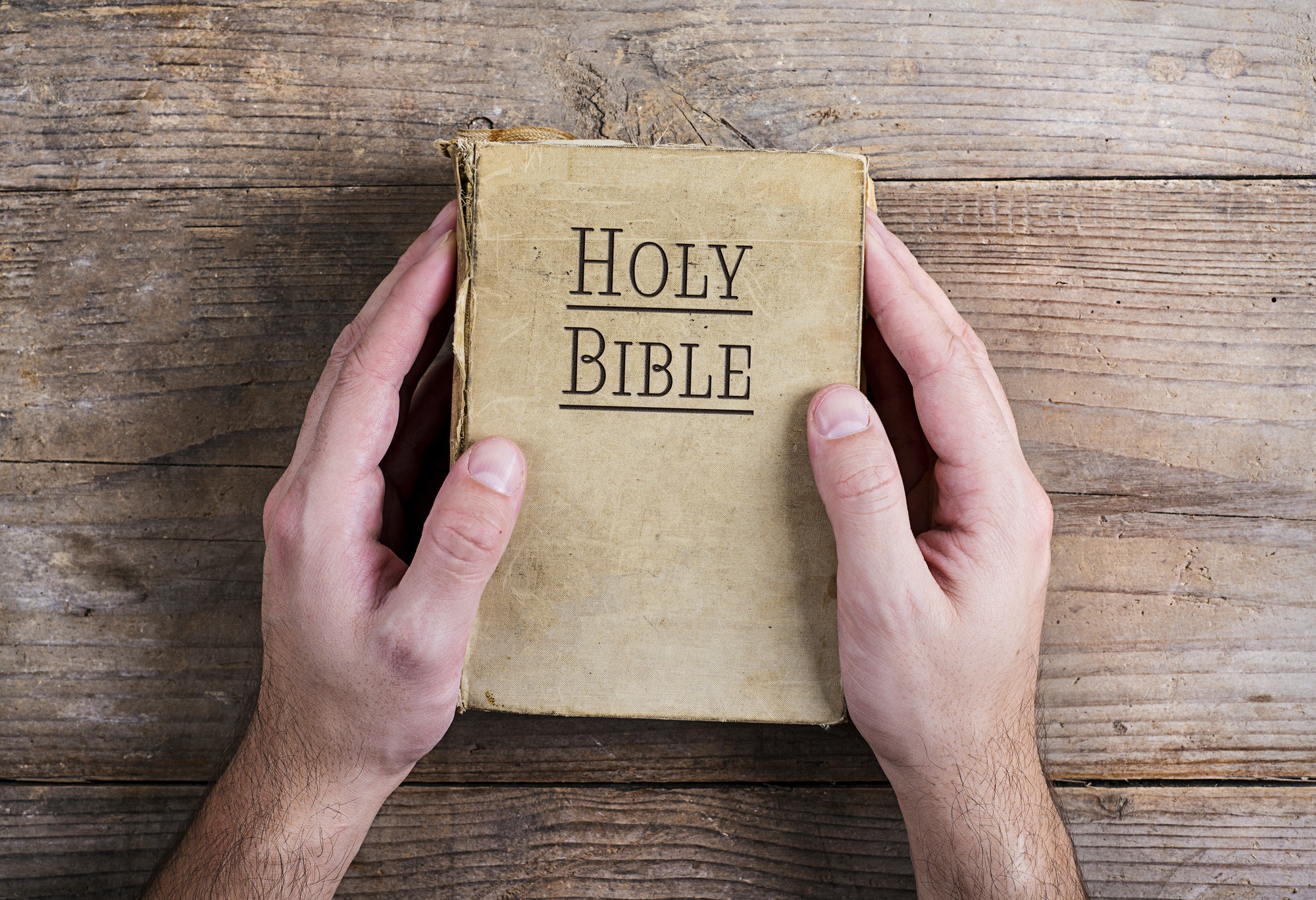 Bible and praying hands